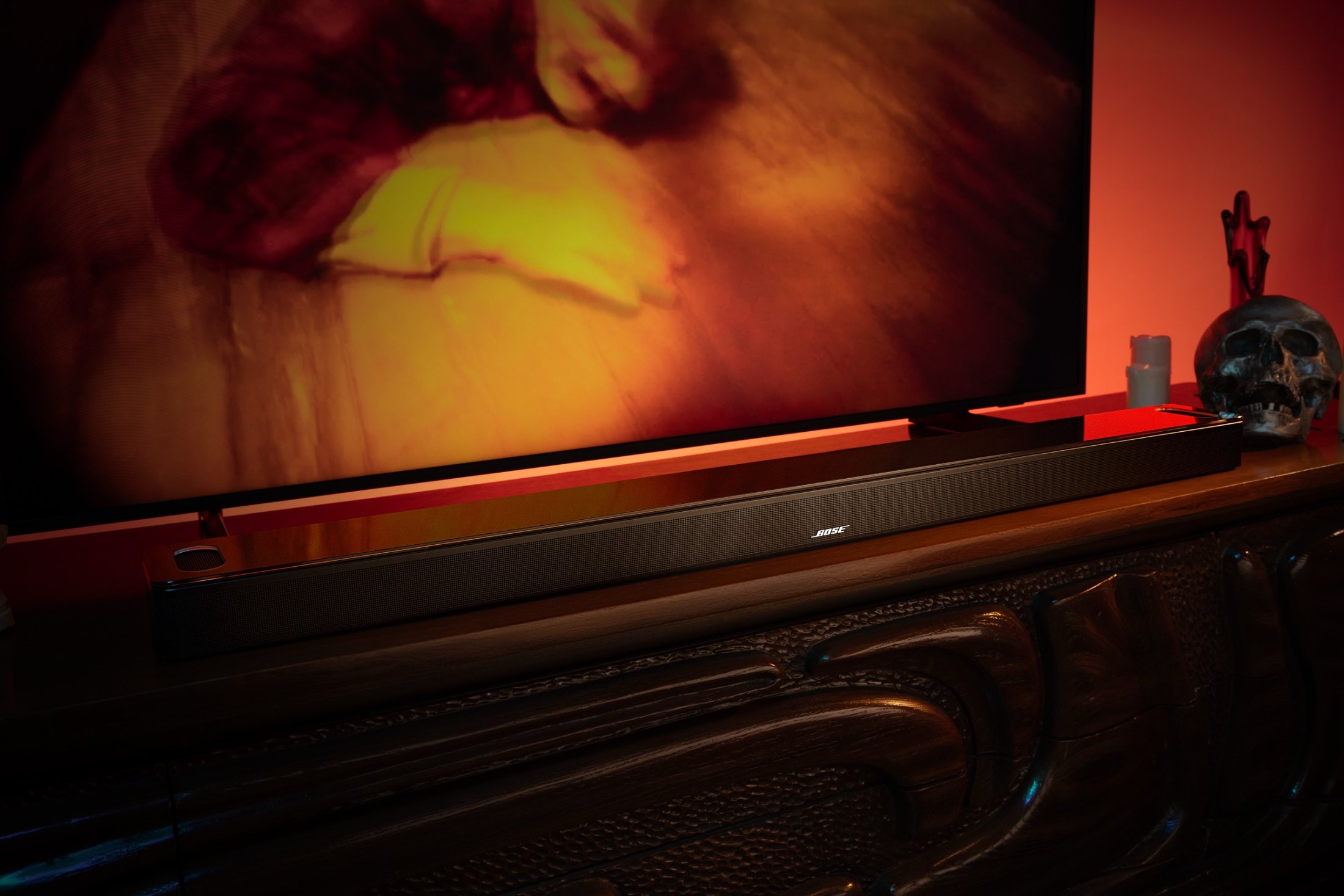 The soundbar in the horror set, a skull beside it, screen glowing