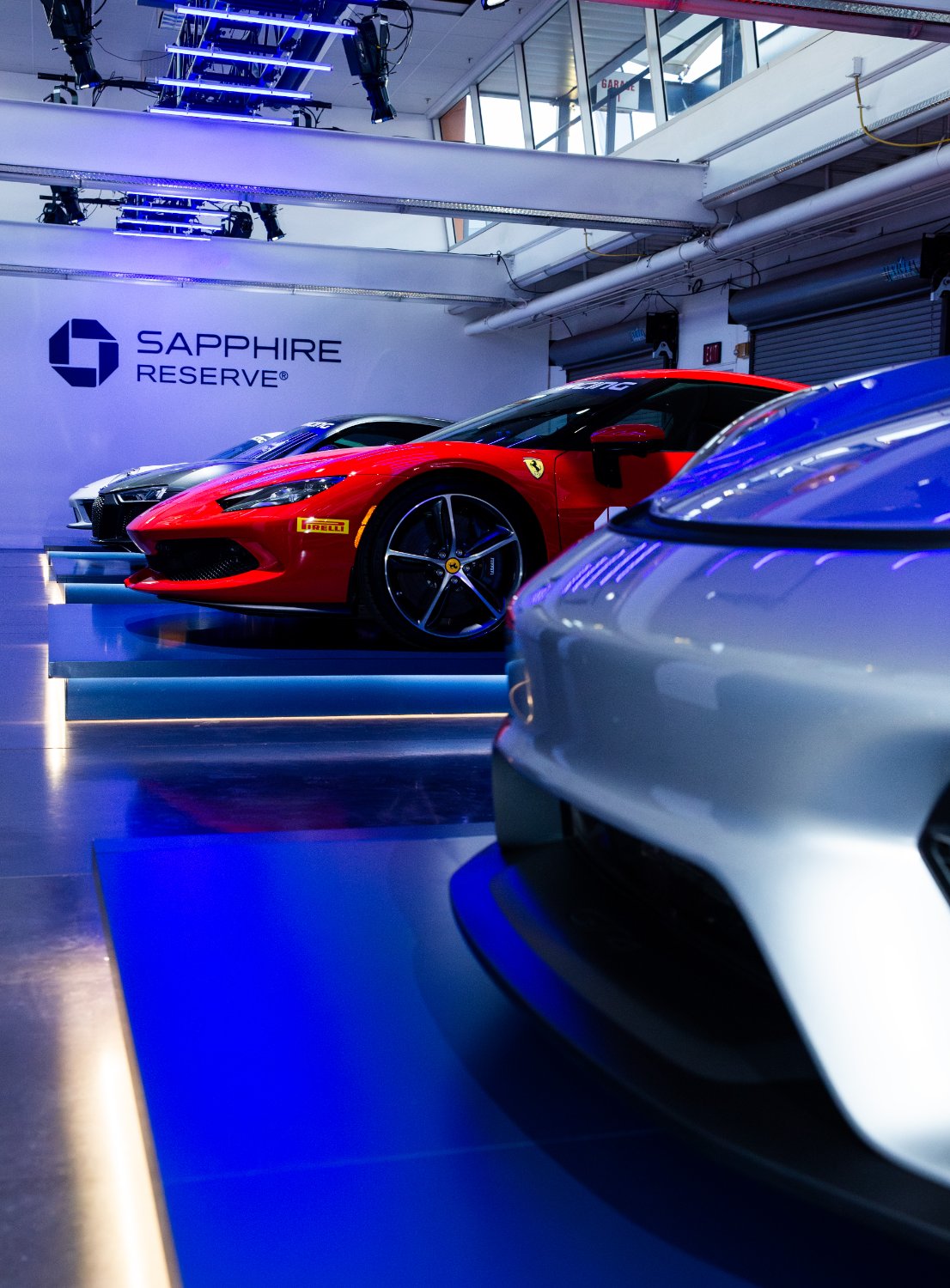 Supercars on display in the garage beneath the Sapphire Reserve wall