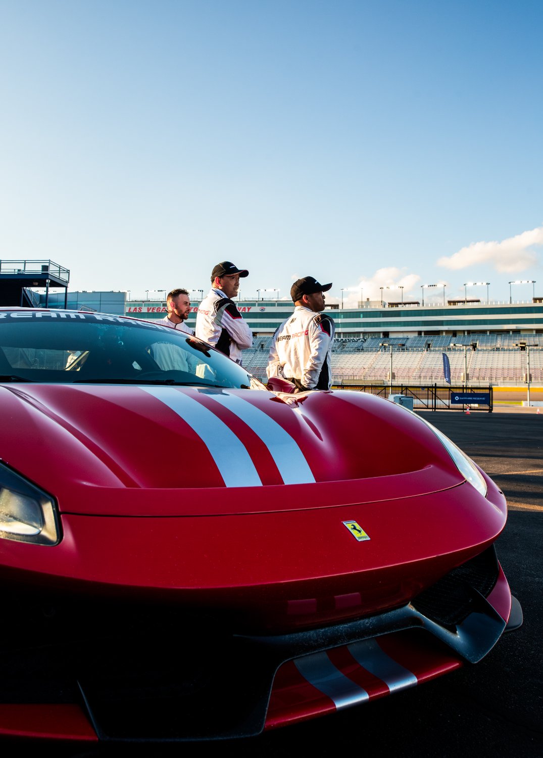 A Ferrari and instructors on the working track at Las Vegas Motor Speedway