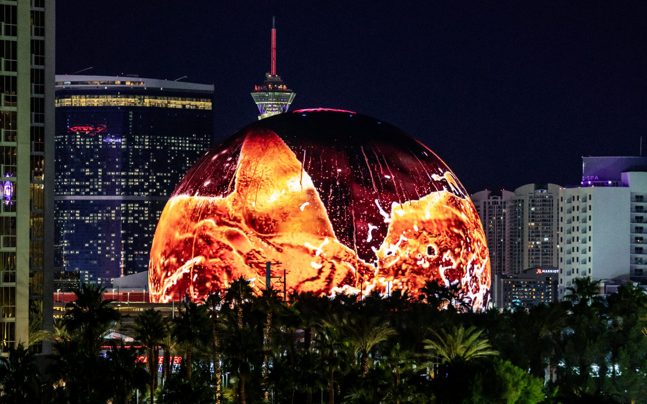 The Coca-Cola pour rendered as molten light across the full dome of the Sphere