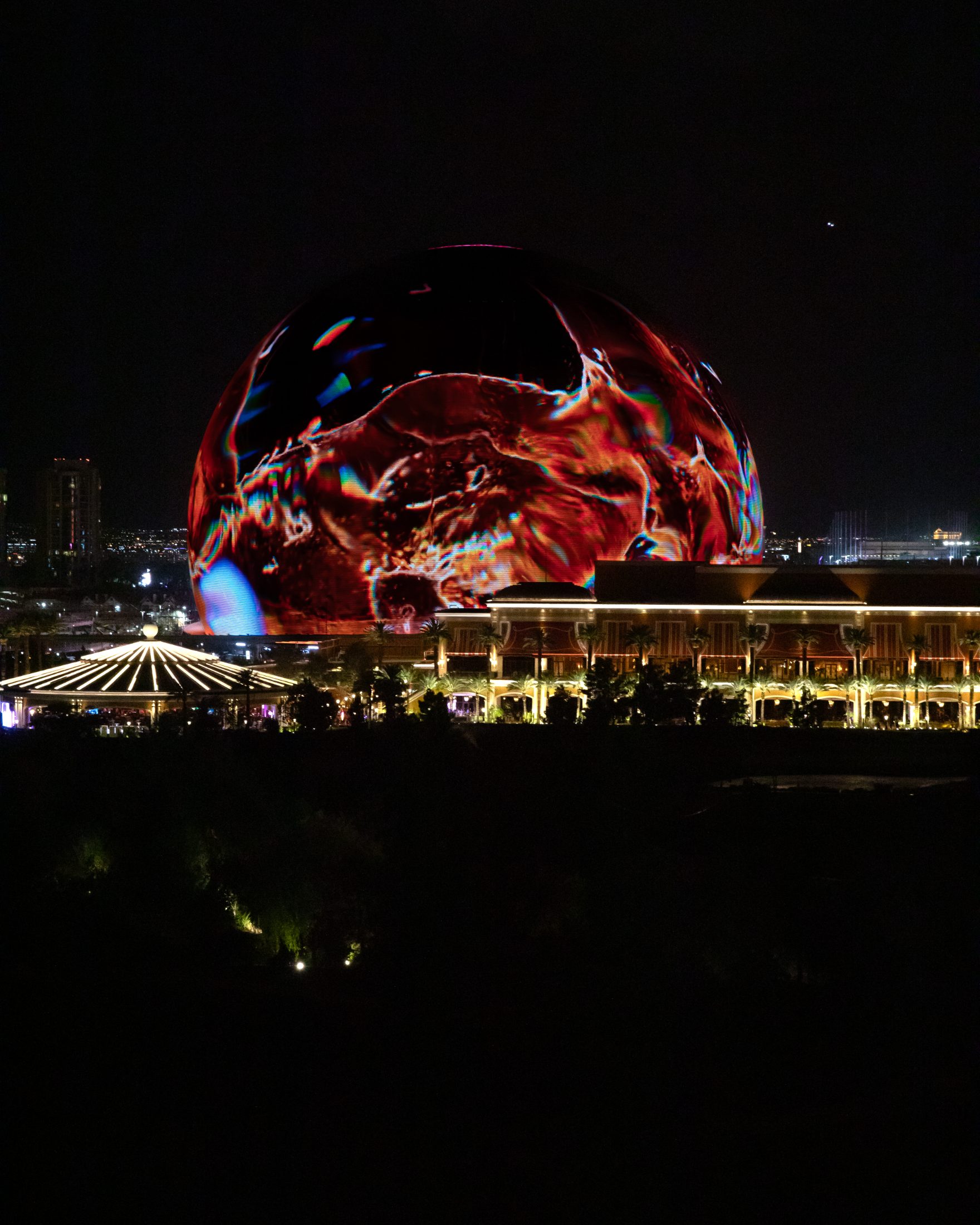 The Sphere towering over the tasting party venue at night