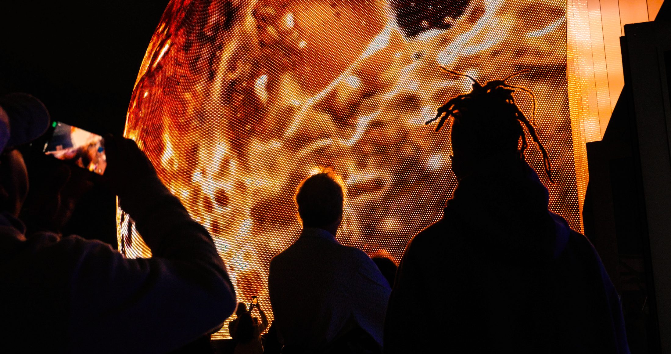 Guests silhouetted against the glowing dome up close