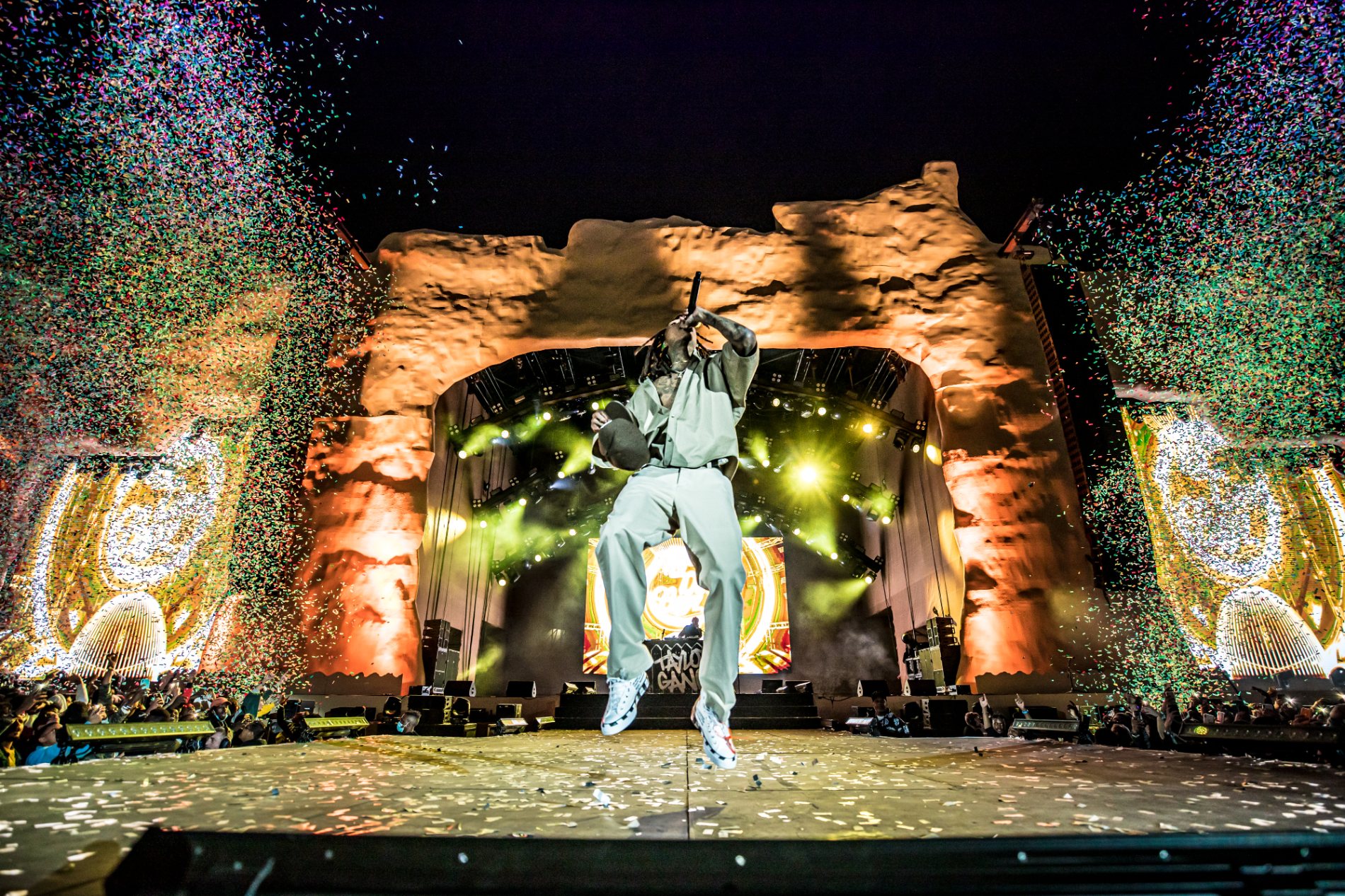 Wiz Khalifa mid-jump on the rock stage, confetti filling the night sky