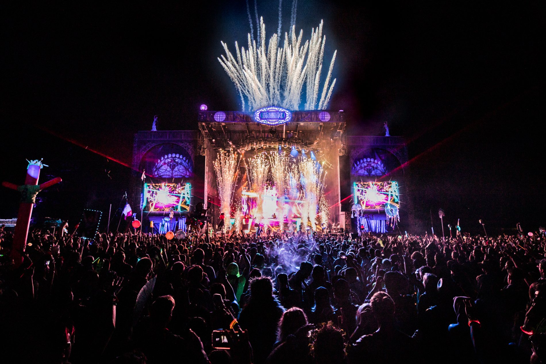 Sparks and pyro raining over the Ranch Arena stage and a vast night crowd