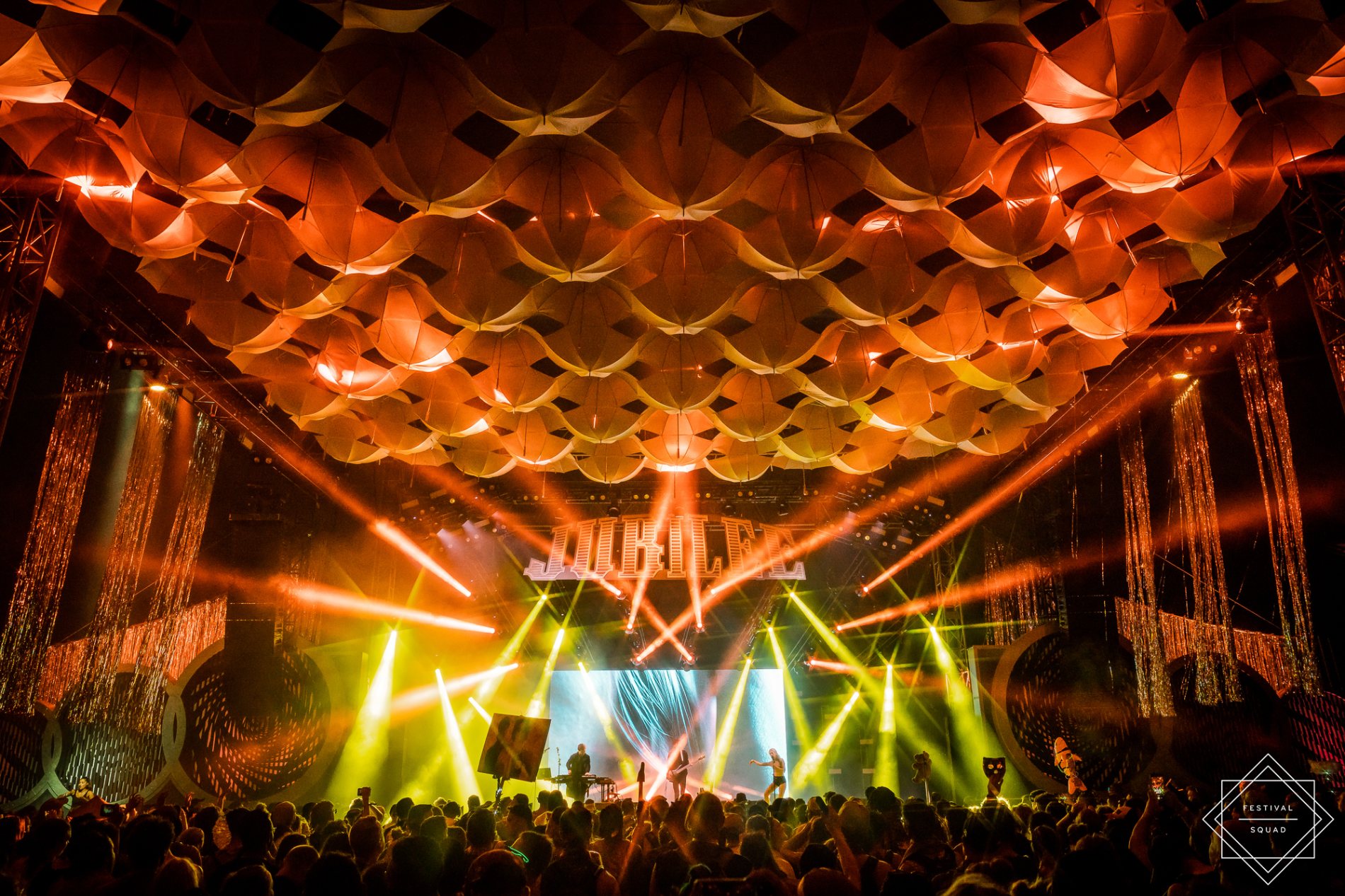 The Jubilee stage under a vast canopy of glowing orange umbrellas