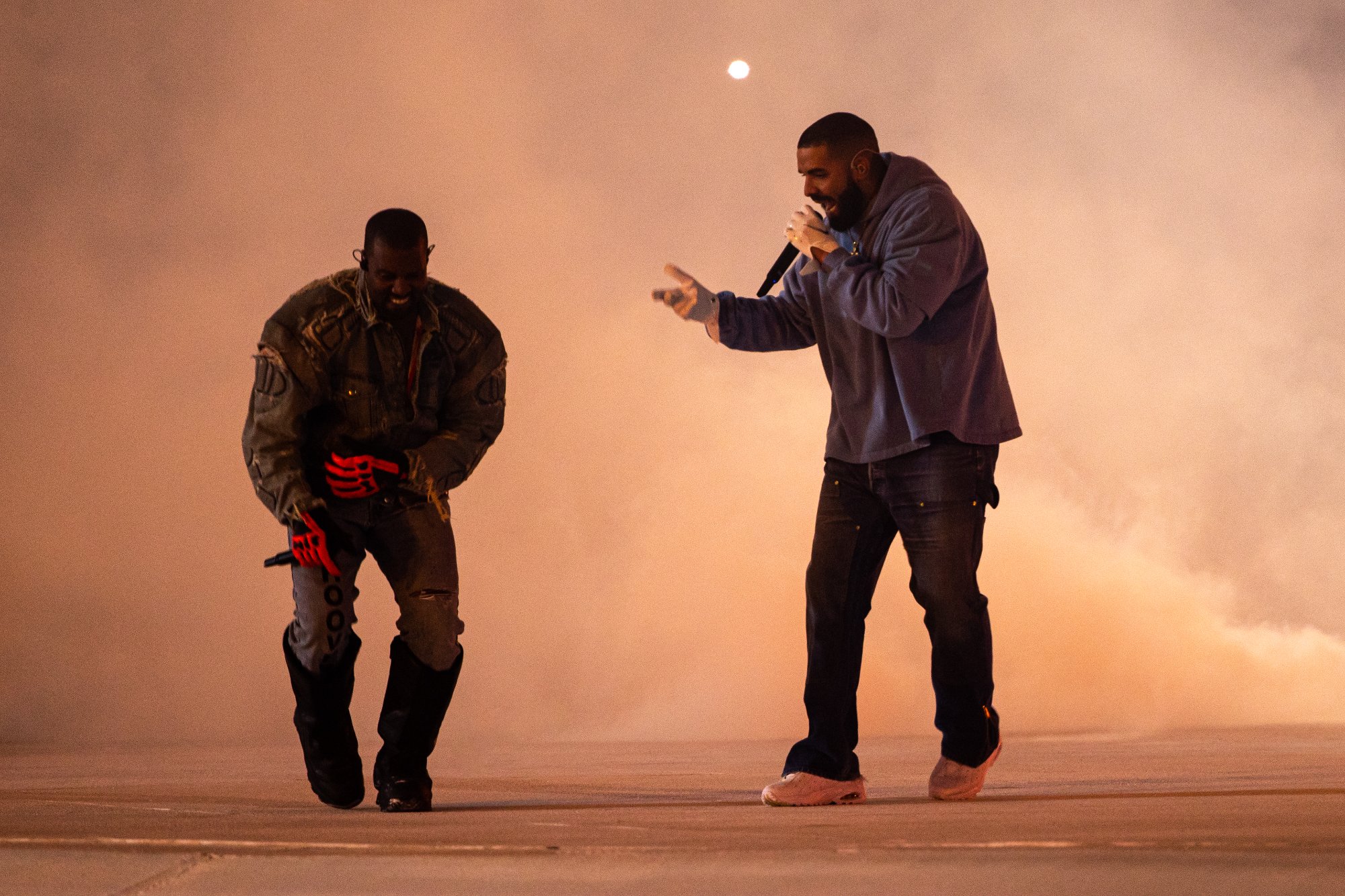 Kanye West and Drake perform together on the field under a full moon