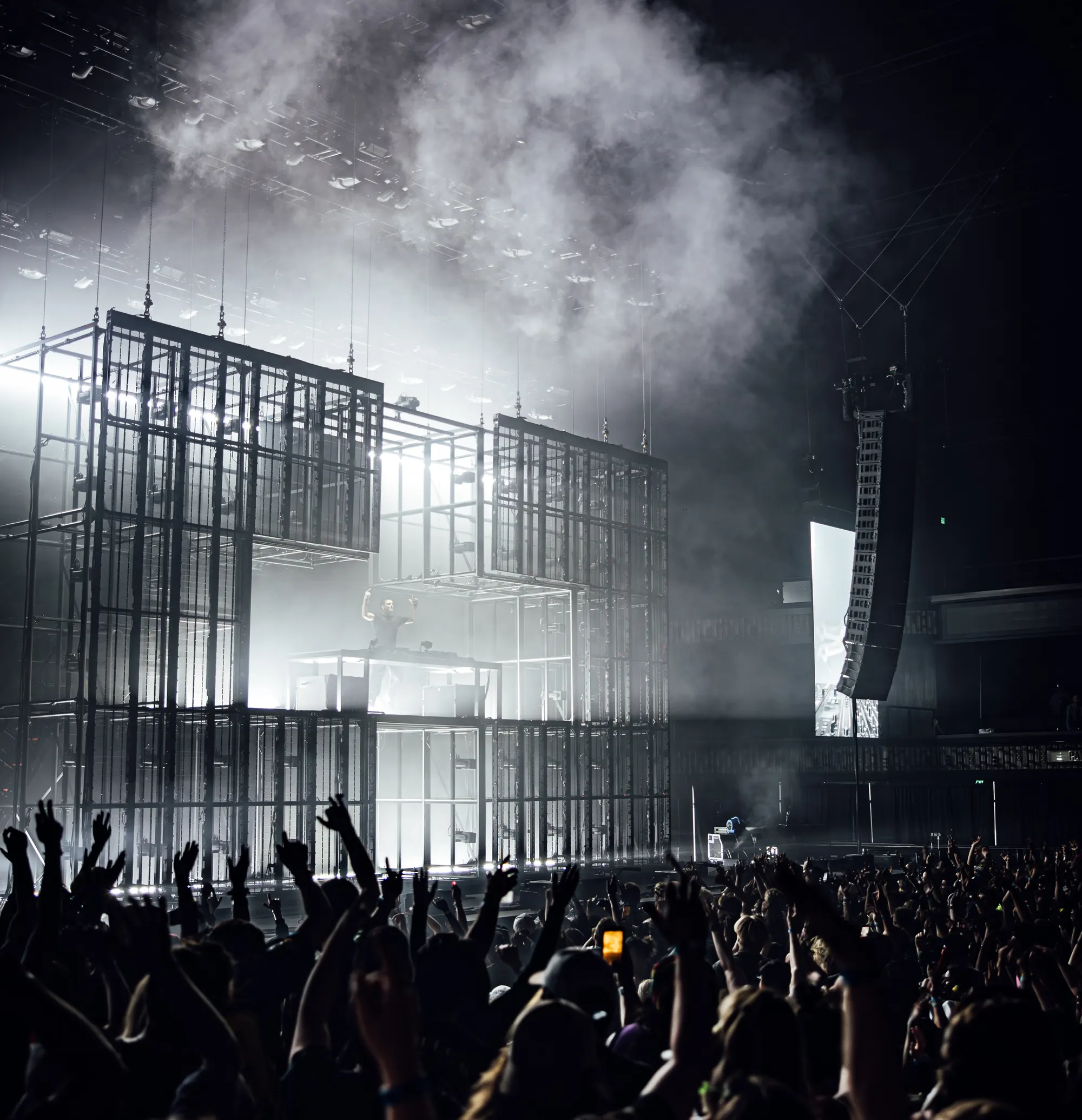 Martin Garrix performing on a towering scaffold stage