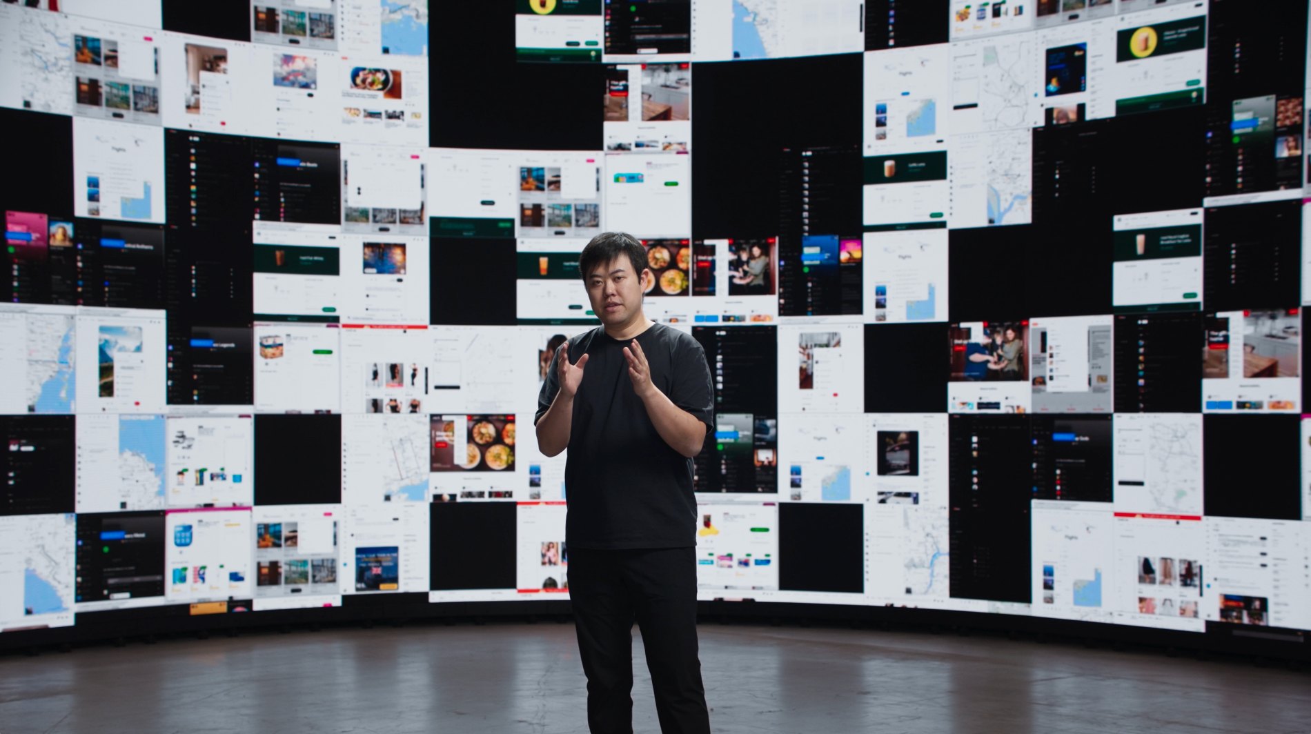 Jesse Lyu on stage in front of a curved wall of app screens