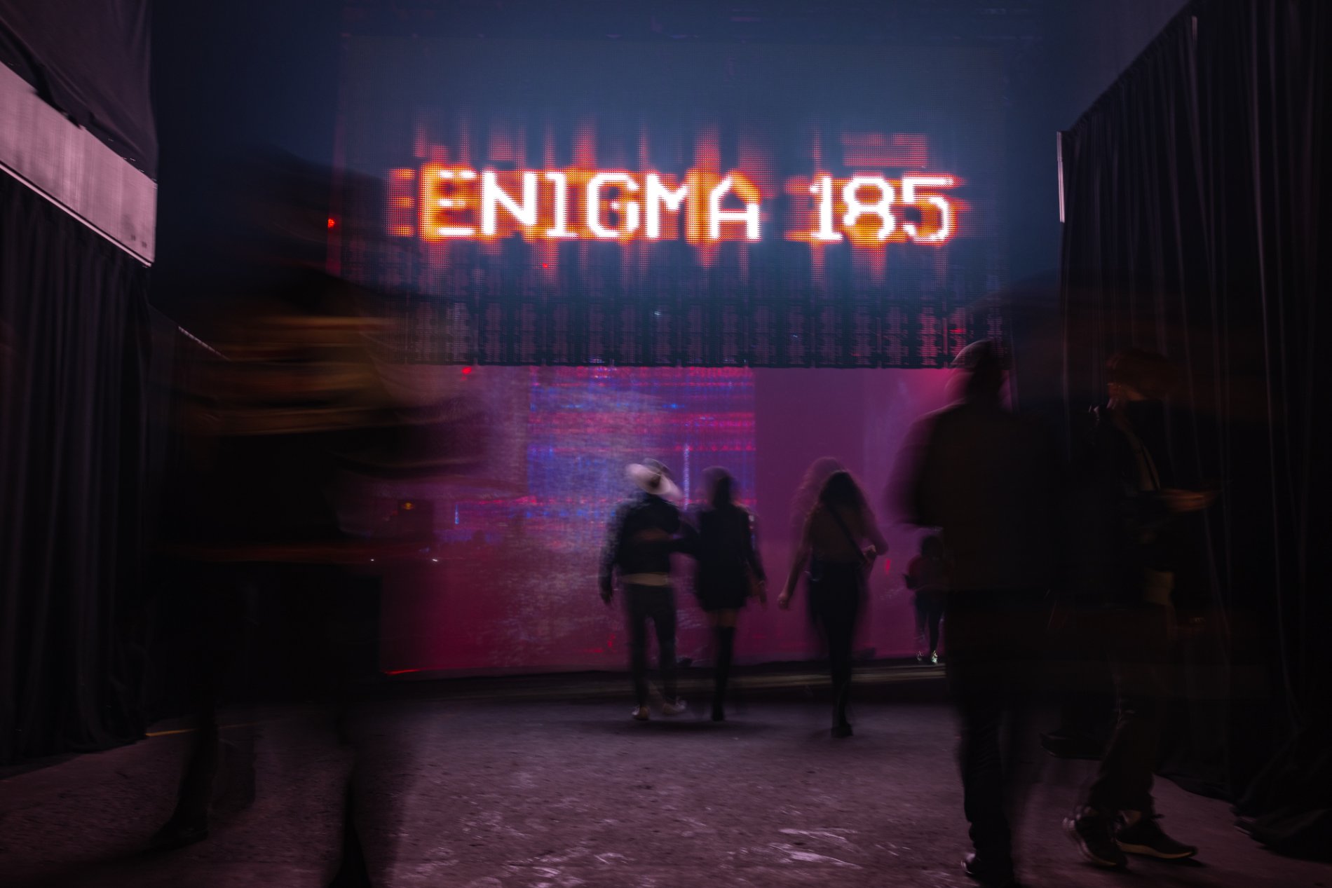 Guests pass beneath the ENIGMA 185 LED marquee at the entrance