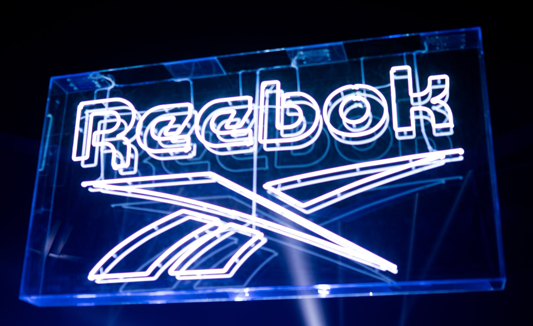 The Reebok vector logo in blue neon