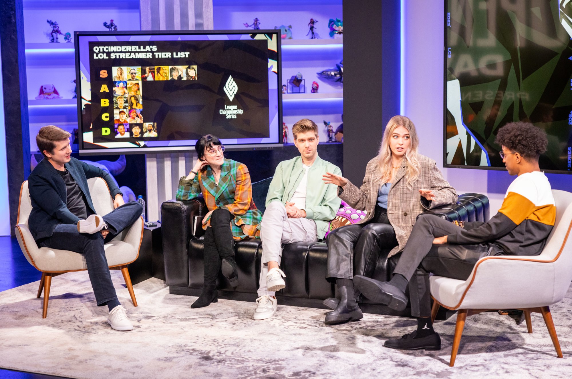 The League broadcast set, hosts running a streamer tier list on the wall screen