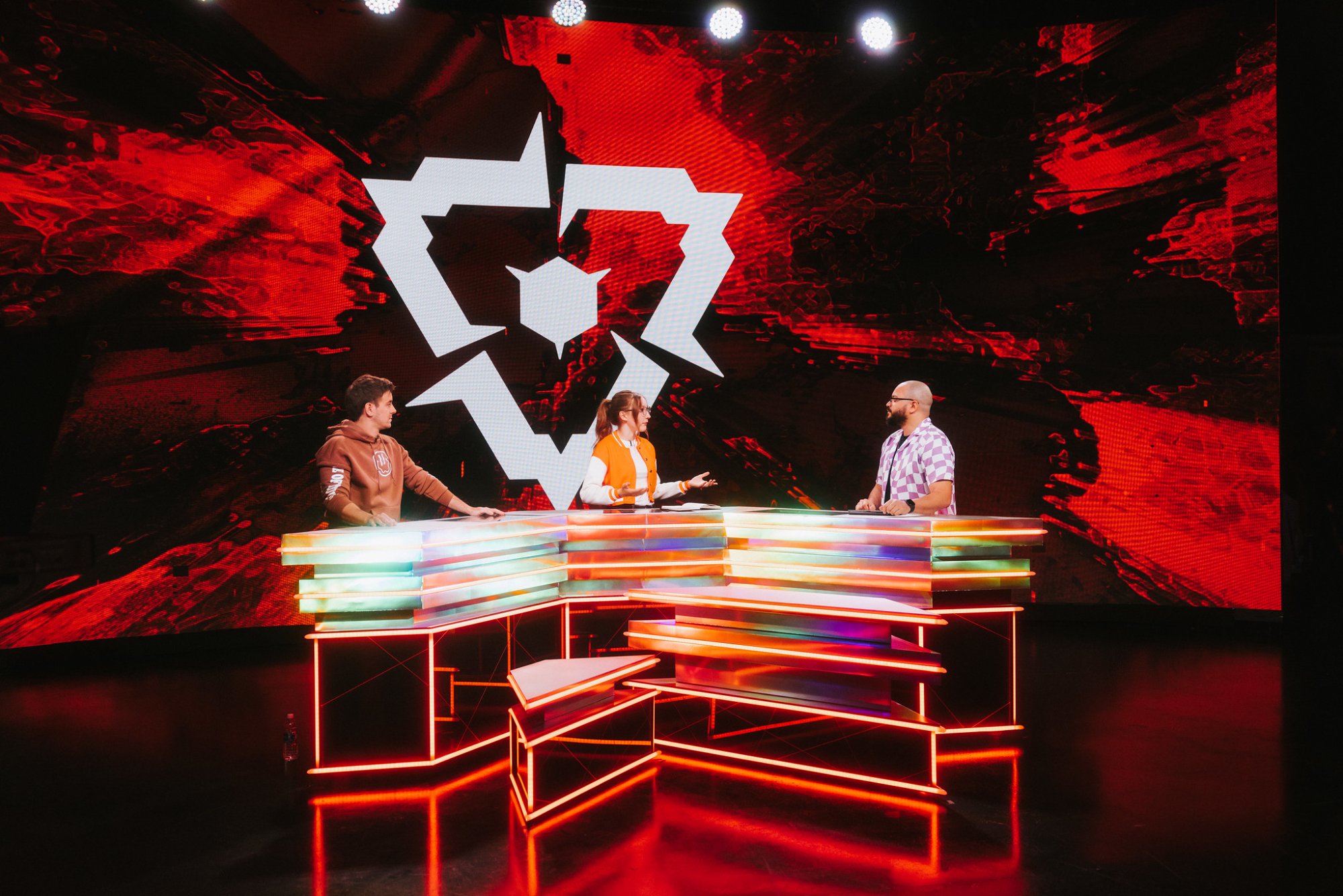 The analyst desk lit in neon under the VCT Americas mark