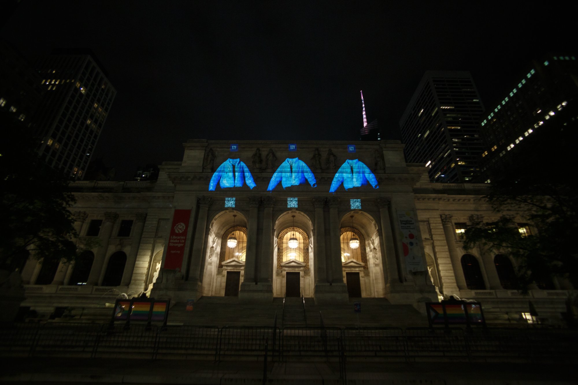 Three jackets projected across the columned facade of the New York Public Library